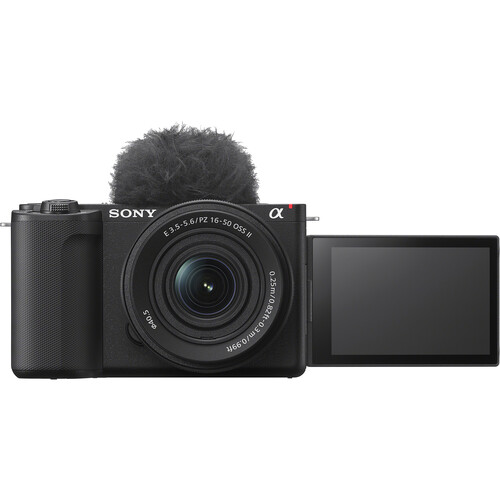 Front view of Sony ZV-E10 II vlogging camera with 16-50mm OSS II lens, top-mounted windscreen, and side-flipped LCD screen